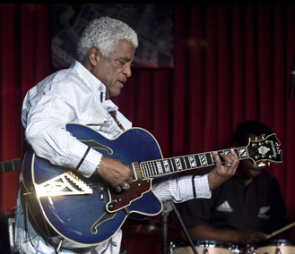 Phil Upchurch tuning a guitar in the studio