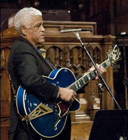 Phil Upchurch in profile holding his instrument