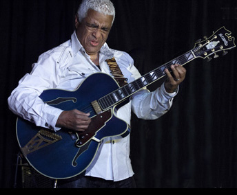 Phil Upchurch smiling while performing live